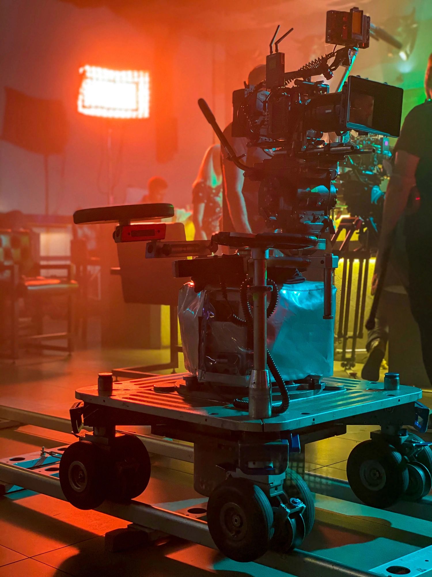 Movie camera on the dolly in the backlight